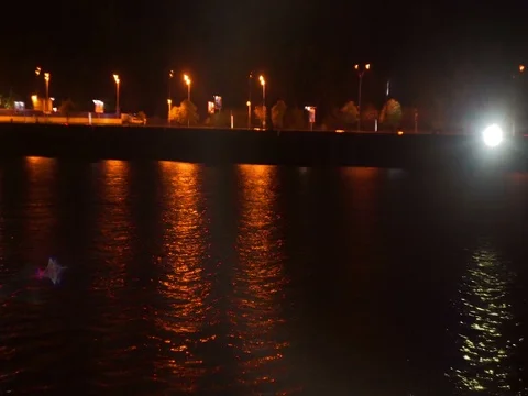 Spotlight shining on the night waterfront Stock-Footage 71863123