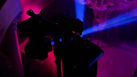 The spotlight shoots multi-colored bright rays of light through the smoke Stock Footage 243680559