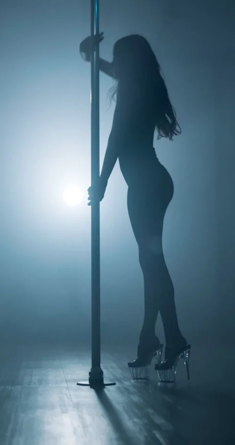 Spotlight, silhouette and pole dancing with woman at night club for stripper Stock Footage 307669394