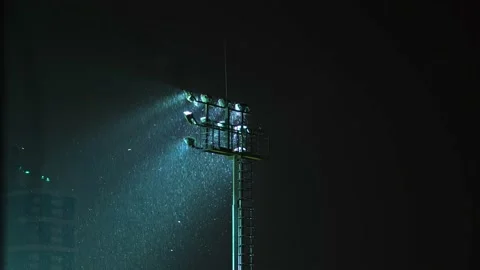 The spotlight of a stadium or prison. night. it's raining or snowing. Stock Footage 162188700