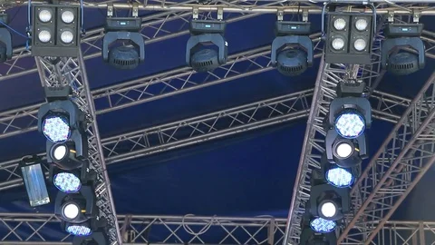Spotlights and lighting devices over stage during the concert Stock Footage 77129074