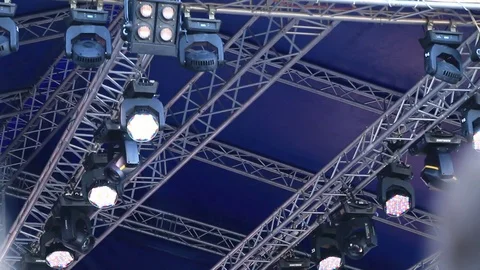 Spotlights and lighting devices over stage during the concert Stock Footage 77129667
