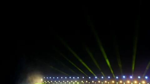 Spotlights and projectors shine over the stage in the dark and fog Stock Footage 312378621