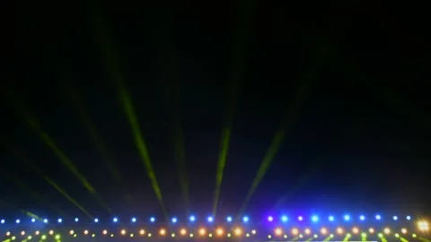 Spotlights and projectors shine over the stage in the dark and fog Stock Footage 312378936