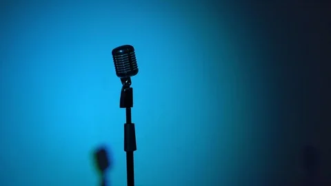 Spotlights blink every second and changes. Chrome mic on multi color background. Stock Footage 118527215