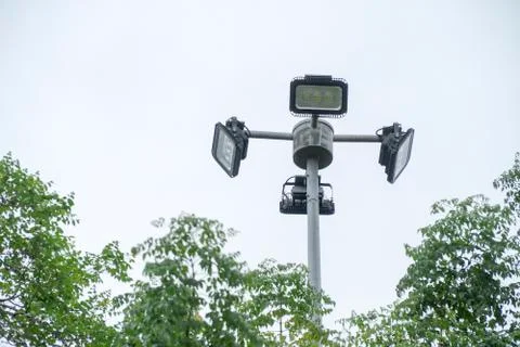 Spotlights in the park with trees. Stock Photos