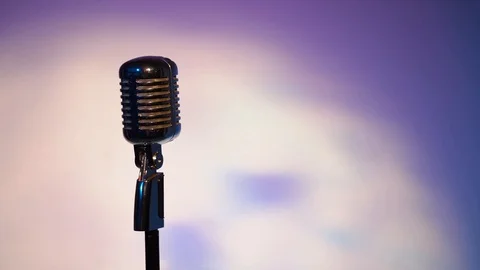 Spotlights shine on a chrome mic with highlights on space fantastic background. Video stock 118529190