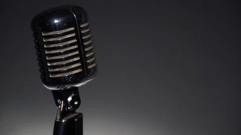 Spotlights shine on a retro chrome micro on the left on gray dark background. Video stock 118527242