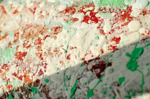 Spots and splashes of white, red and green paint on background. abstract patt Stock Photos