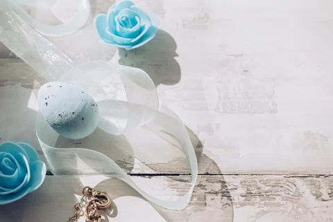 Spotted blue Easter egg decor with organza ribbon and flowers on wooden backg Stock Photos