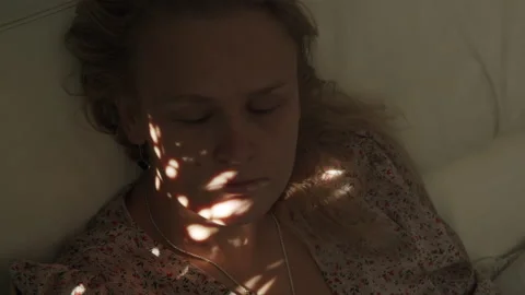 Spotted sunlight on her face Stock Footage 145004105