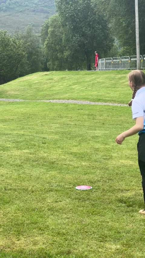 Spotter's Minimal Effort Limbo to Avoid Thrown Frisbee, Sula, Norway - 26 Jun 20 Stock Footage 329506940