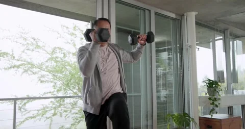 Spotting weights on mat, Senior Asian man grasping them, doing shoulder presses Stock Footage 337254953