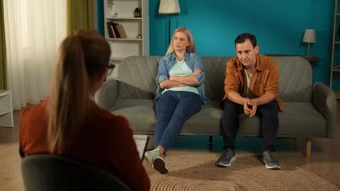 Spouses avoid talking after a marital argument, wife and husband sit on the Stock Photos