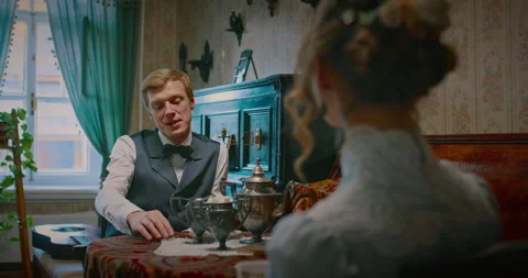 Spouses drinking tea and talking after dinner in interior of 19 century, retro Stock Footage 258868179