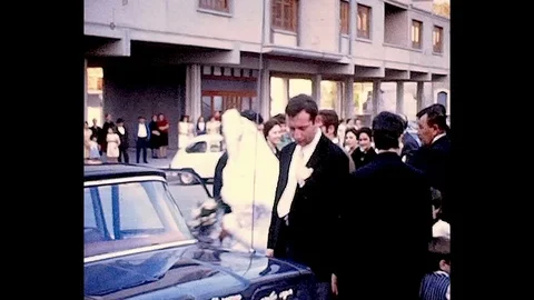 Spouses enter the car, 1969 Stock Footage 98575753