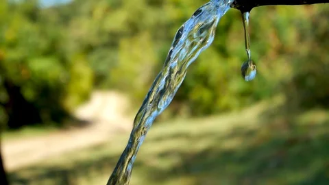 Spout of a mountain fountain with crystalline, pure and bright water. Close-u Stock Footage