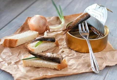 Sprats in can and bread Stock Photos