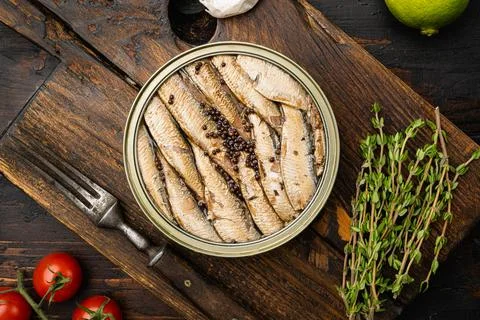 Sprats tin can, on old dark wooden table background, top view flat lay Stock Photos