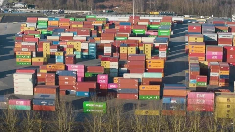Sprawling container terminal canal multicolored containers major brands stacked Stock Footage 329079564