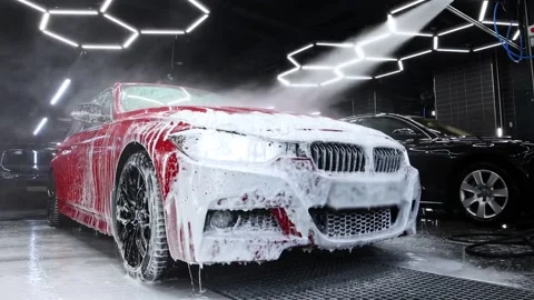 Spray the automobile with water using a sprayer In the vehicle wash Stock Footage 171593387