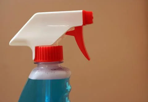 Spray bottle on beige background Foto stock