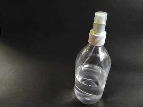 Spray bottle on black background. Stock Photos