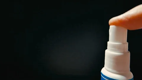 Spray bottle drops on black background, slow motion Stock Footage 101323852