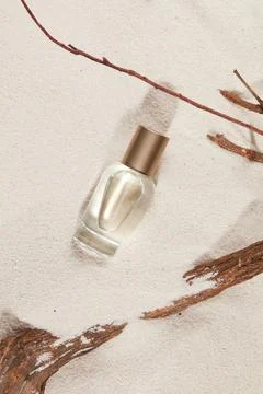 Spray bottle with empty label on natural sand top view, dry branches. Natur.. Stock Photos