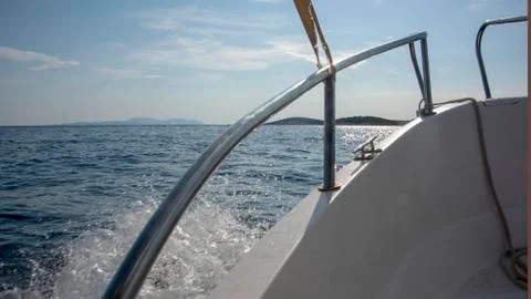Spray breaking against the prow of a small motor boat as it crosses the bay Stock Photos