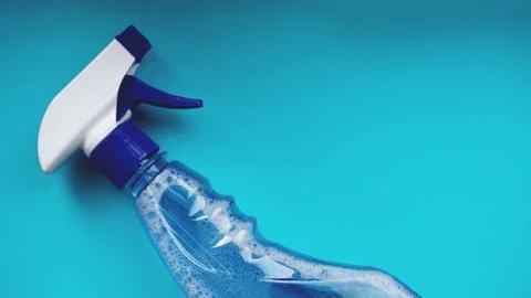 Spray with detergent on blue background Stock Photos