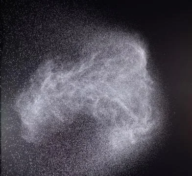 A spray of liquid in a black background. Foto stock