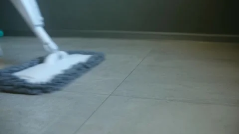 Spray mop cleaning modern tile floor Stock Footage 321738251