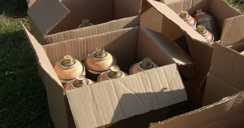 Spray paint cans in cardboard boxes Video stock 238857091