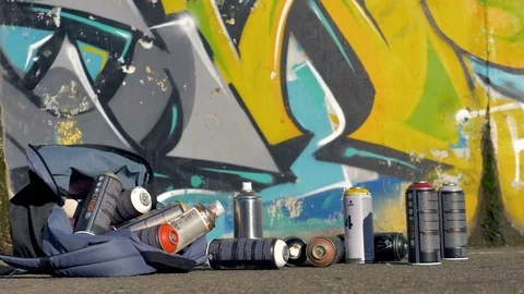 A bag full of spray paint bottles falls , Stock Video