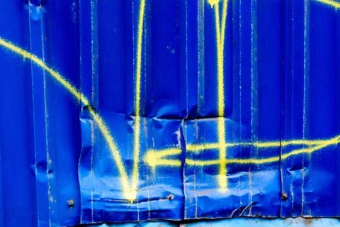 Spray painted on dented, rusty highway. Dent on metal graffiti Stock Photos