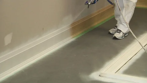 Spray Painting the baseboard Stock Footage 111498093