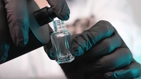 Spray perfume into a small bottle Stock Footage 158463464