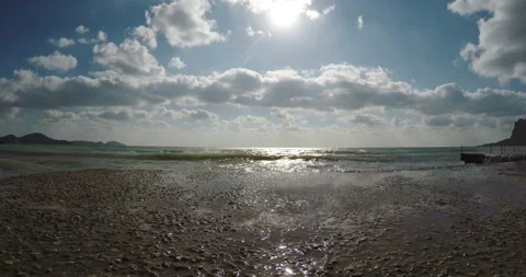 Spray from the surf on the pier against the background of clouds and the sun Stock Footage 85632603