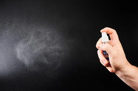 Spray transparent liquid from flask Stock Photos