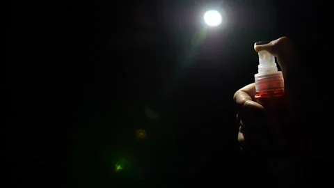 Spray woman's hand on black background in dark Stock Footage 105067765