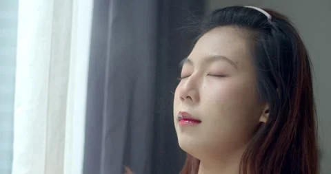 Spray on your face to lock in makeup to make it last longer. Stock Footage 310015804