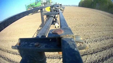 Sprayer nozzle in operation, tractor sprayer works in the field. Stock Footage 92799833