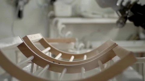 A sprayer of paint is released onto elements of wooden furniture Video stock 232888468