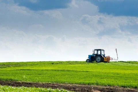 Sprayer tractor in a wheat field in the spring Stock Photos