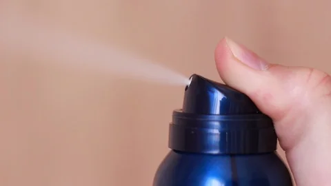 Spraying aerosol or deodorant Stock Footage 86894486