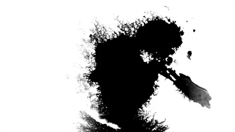 Spraying black paint on a white background Stock Footage 303171611