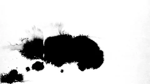 Spraying black paint on a white background Stock Footage 303171757