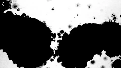 Spraying black paint on a white background Stock Footage 303171758
