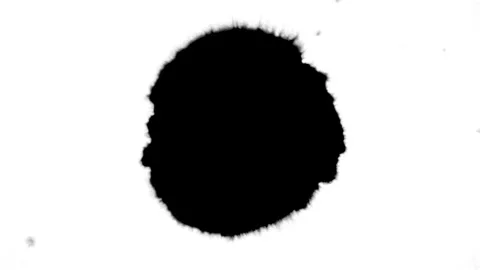 Spraying black paint on a white background Stock Footage 303171813